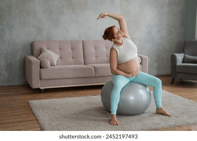 Pregnant woman doing lateral bends on a fitball at home.  - Powered by Shutterstock