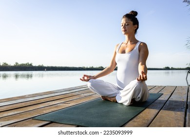Premium Photo  An elderly woman practicing yoga on the shore of a lake in  summer meditation sports in old age