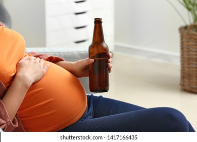 Pregnant Woman Drinking Beer At Home