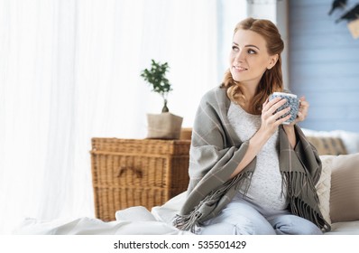 Pregnant Woman Drinking Tea In Bed