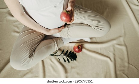 Pregnant Woman Eating Apple At Home. Healthy Food, Vegan Low Sugar Diet Concept. Healthcare, New Life, Wellbeing, Fertility, Unborn Baby Health. Oral Glucose Tolerance Test.