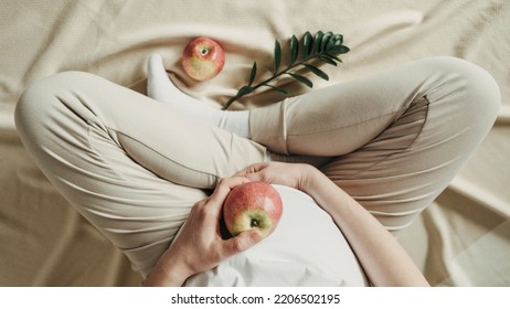 Pregnant Woman Eating Apple At Home. Healthy Food, Vegan Low Sugar Diet Concept. Healthcare, New Life, Wellbeing, Fertility, Unborn Baby Health. Oral Glucose Tolerance Test.