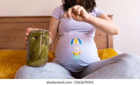 pregnant woman eating pickles. Pregnant woman holding jar with pickles. Pregnancy food cravings concept - Shutterstock ID 2262670341