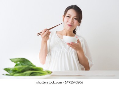 Pregnant Woman Eating Spinach Deliciously