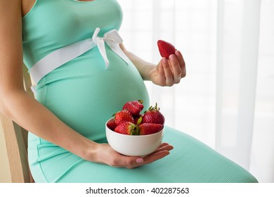 Pregnant Woman Eating Strawberries 