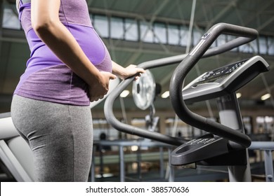 Pregnant woman exercising in the gym