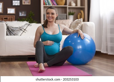 Pregnant Woman Exercising At Home 