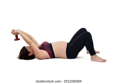 pregnant woman exercising on the floor with dumbbell on white background