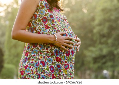 Pregnant woman feeling the baby. - Powered by Shutterstock