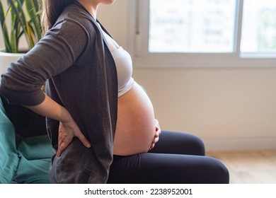 Pregnant woman feeling labor contractions - Shutterstock ID 2238952001