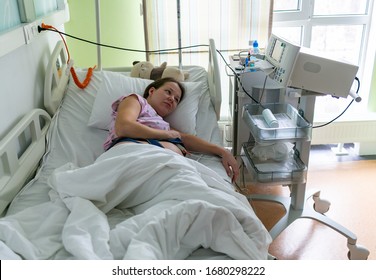 Pregnant Woman Feels Hard Contraction In A Hospital Labor Delivery Room. Concept Photo Of Pregnancy, Pregnant Woman, Newborn And Baby.