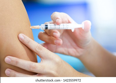 Pregnant woman get flu, measles vaccine shot, vaccination in hospital for good heath, medicine and drug concept