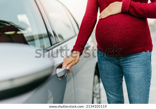 The pregnant woman gets in the car and goes\
for a medical examination.