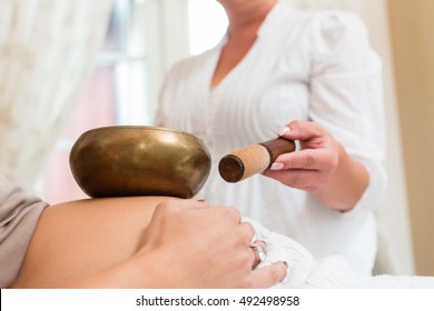 Pregnant woman getting sound bowl wellness treatment - Shutterstock ID 492498958