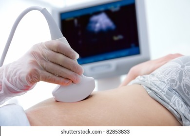 Pregnant woman getting ultrasound from doctor - Powered by Shutterstock