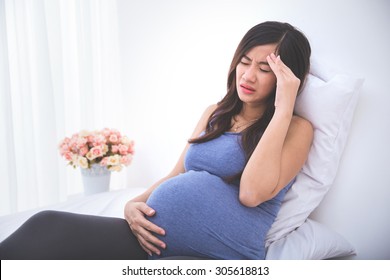 Pregnant Woman Having A Headache And Morning Sickness