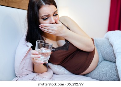 Pregnant woman having nausea and feeling ill