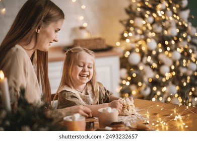 pregnant woman and her 3 year old daughter near the New Year tree in kitchen cooking. Noise blurred toned vintage film grain image	 - Powered by Shutterstock