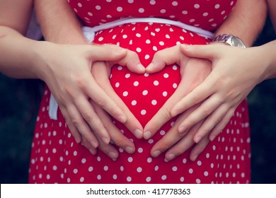 Pregnant woman with her hands on her belly - Powered by Shutterstock