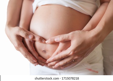 Pregnant woman and her husband holding hand together, 2 hands holding baby inside a pregnant woman, love of family, Parenting
