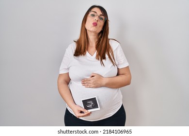 Pregnant Woman Holding Baby Ecography Looking At The Camera Blowing A Kiss Being Lovely And Sexy. Love Expression. 