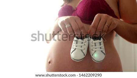 Similar – Image, Stock Photo Baby sneakers held by pregnant