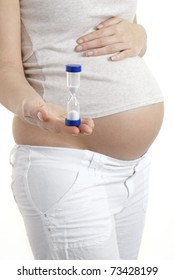 Pregnant Woman Holding Egg Timer (conceptual - Time Running Out)