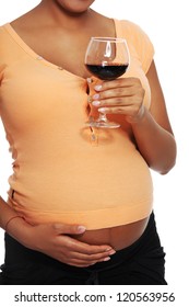 Pregnant woman holding glass of alcohol ( wine ), isolated on white