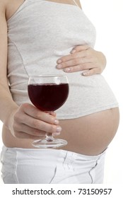 Pregnant woman holding glass of wine