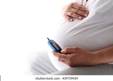 Pregnant Woman Holding Glucose Meter. Gestational Diabetes. 