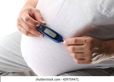 Pregnant Woman Holding Glucose Meter. Gestational Diabetes. 