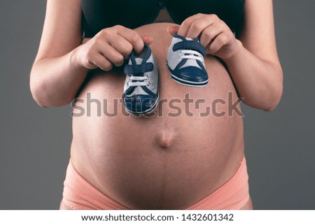 Similar – Image, Stock Photo Baby sneakers held by pregnant