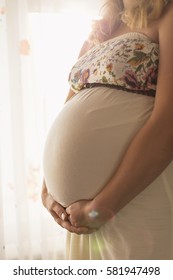 Pregnant woman holding her belly  