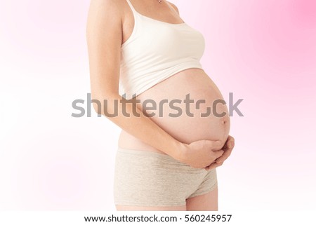 Pregnant woman holding her belly , isolated
