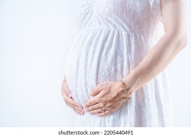 A Pregnant Woman Holding Her Stomach In A Maternity Dress White Background (shooting A Real Pregnant Woman)