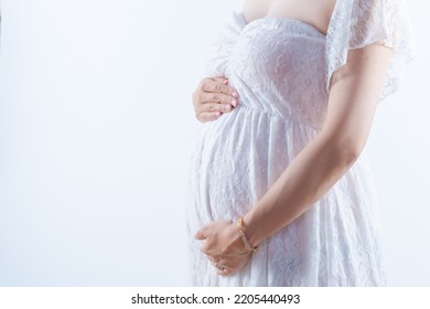 A Pregnant Woman Holding Her Stomach In A Maternity Dress White Background (shooting A Real Pregnant Woman)