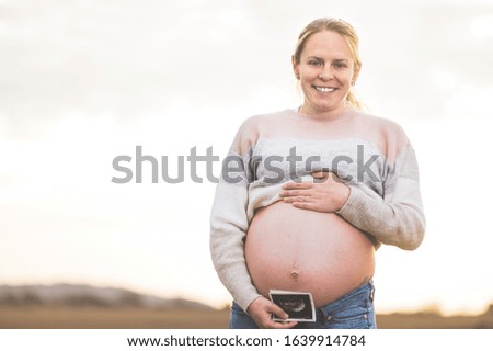 Similar – Unrecognizable pregnant woman showing ultrasound of her baby on the mobile