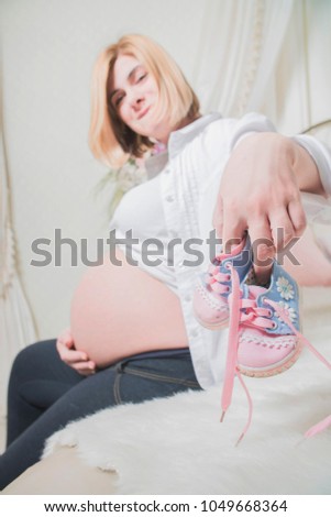 Similar – Image, Stock Photo Baby sneakers held by pregnant