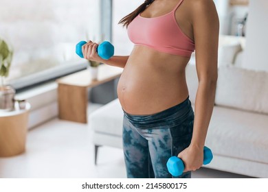 Pregnant Woman Home Workout. Fitness Strength Training Exercise With Dumbbell Weights. Body Workout Arm Curls Closeup Of Belly And Arms