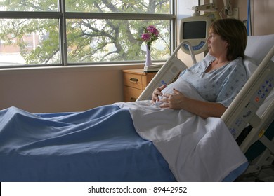 Pregnant woman in the hospital bed awaiting the birth of a child.