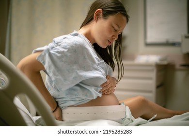 A pregnant woman in the hospital delivery room having contractions. Childbirth and labor. - Powered by Shutterstock