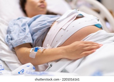 A pregnant woman in the hospital delivery room with a IV drip. Childbirth and contractions. - Powered by Shutterstock