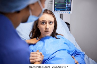 Pregnant woman, hospital and labor with push, holding hands or midwife at bed, baby and talking. Strong mother, childbirth and nurse with helping hand, advice and care for healthy delivery in clinic - Powered by Shutterstock