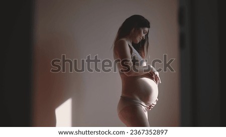 pregnant woman. indoors health pregnancy motherhood procreation concept. close-up belly of a pregnant woman. woman waiting for a newborn baby. pregnant woman holding her belly sunlight