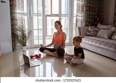 Pregnant woman and kid in sport clothing exercising at home. Online training during coronavirus covid-19 quarantine. Stay fit and safe during pandemic lockdown. Sport, fitness, healthy concept