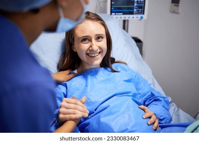 Pregnant woman, labor and hospital with holding hands, bed and support from nurse, excited smile and pain. Strong mother, midwife and helping hand in clinic for infant child, motivation and new life - Powered by Shutterstock