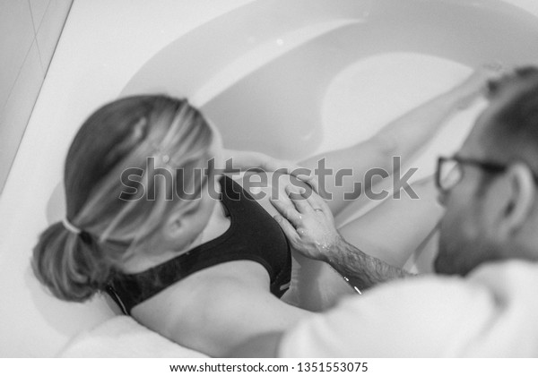Pregnant woman in labour, labor, 
during childbirth, giving birth, birthing pool, water
bath
