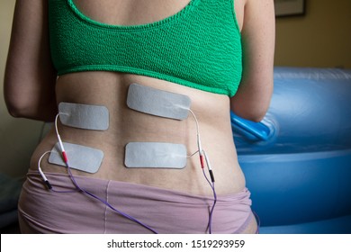 A pregnant woman in labour wearing a tens machine as pain relief