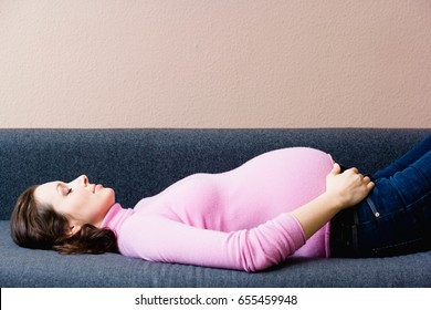 Pregnant woman laying couch