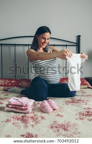 Image, Stock Photo Pregnant woman looking baby girl body